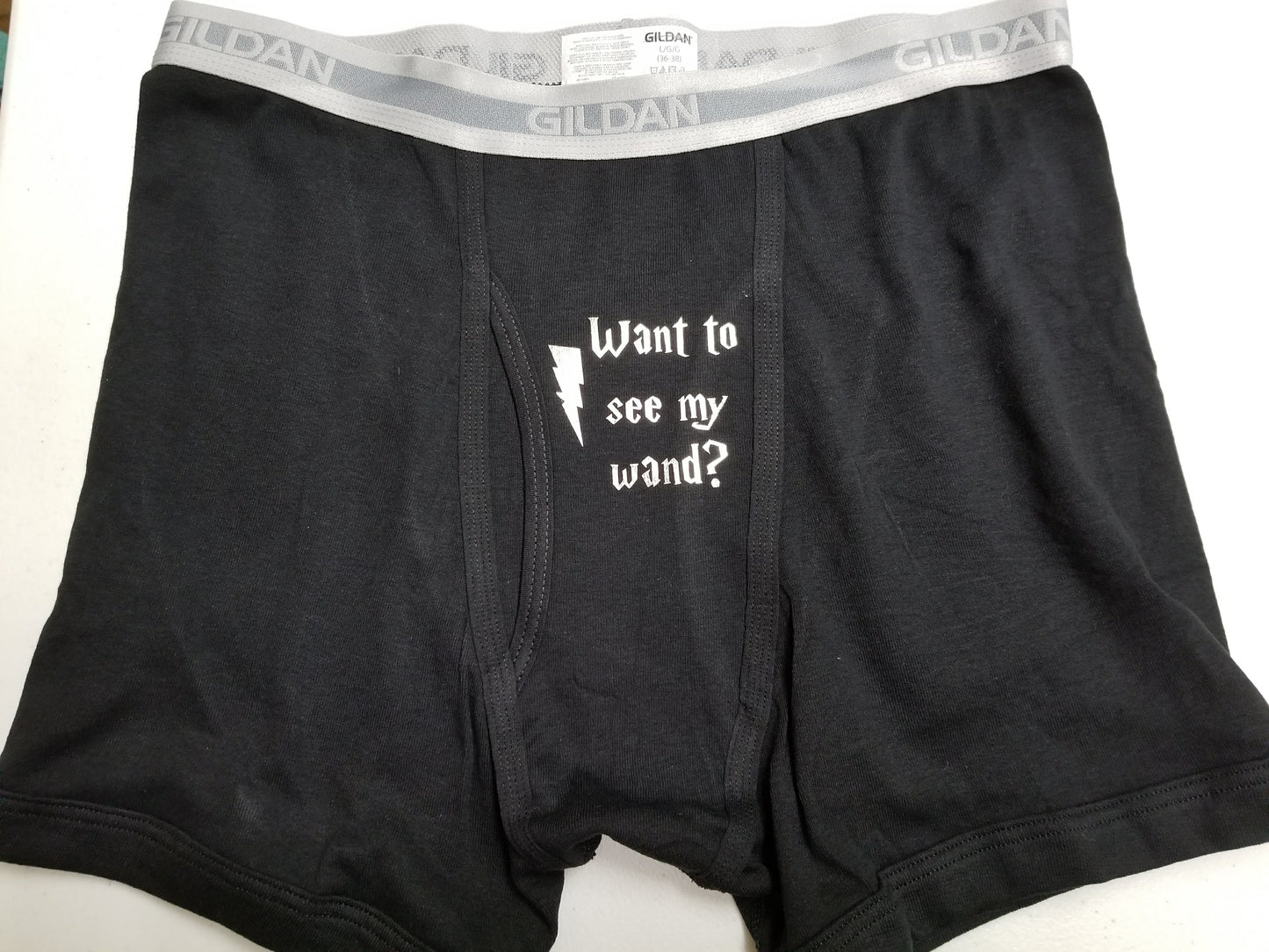 Black boxer briefs with “Want to See My Wand?” and lightning bolt
Cheeky wizard-themed underwear – wand joke design
Funny black or grey underwear with wand humor