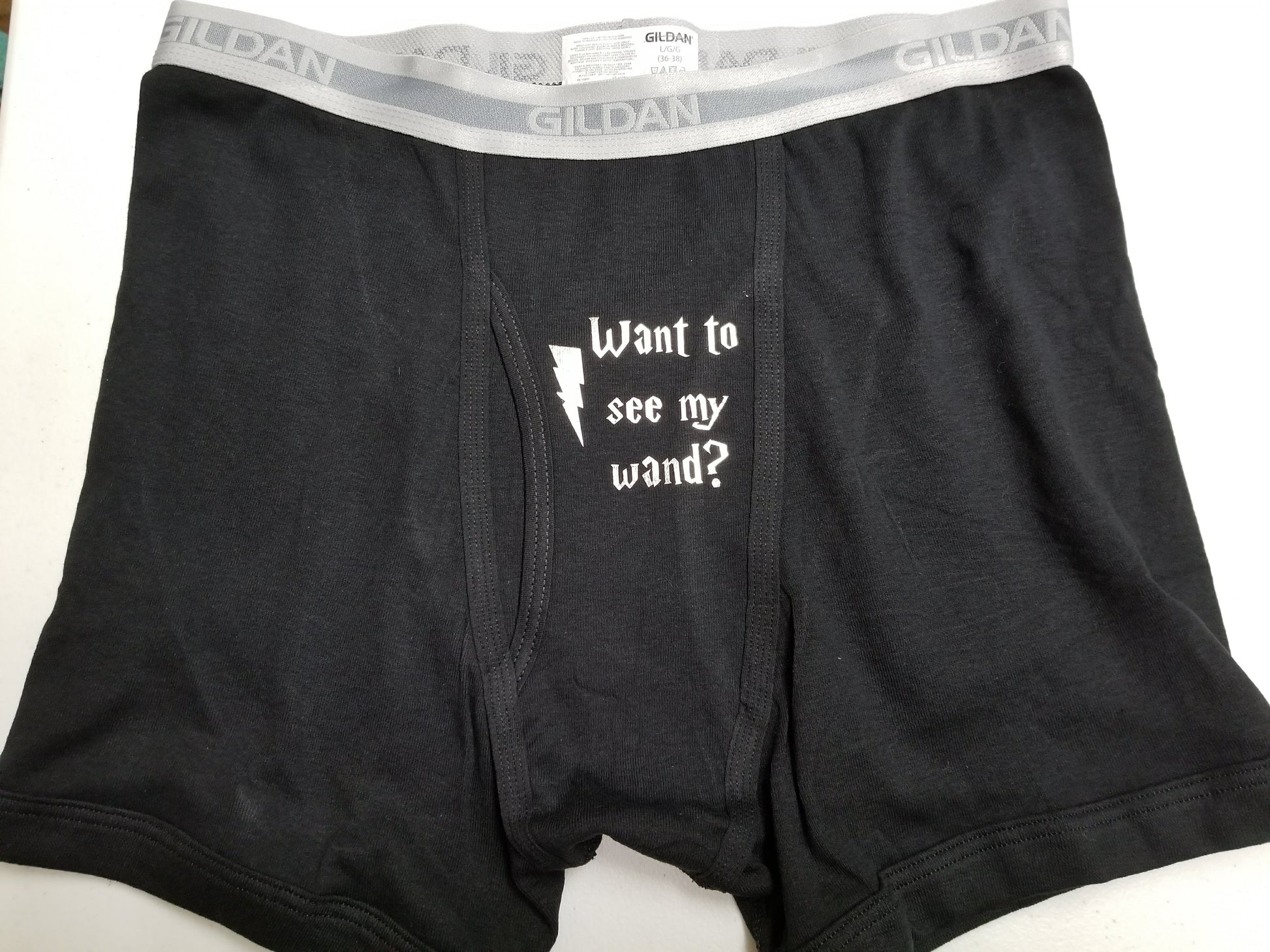 Black boxer briefs with “Want to See My Wand?” and lightning bolt
Cheeky wizard-themed underwear – wand joke design
Funny black or grey underwear with wand humor