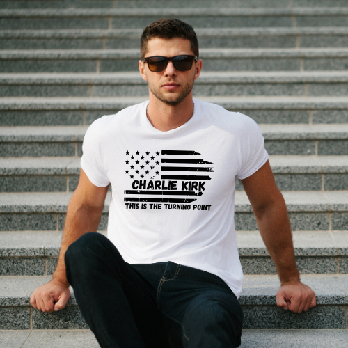 Man wearing a white t-shirt with 'Charlie Kirk This is the Turning Point' design on steps.