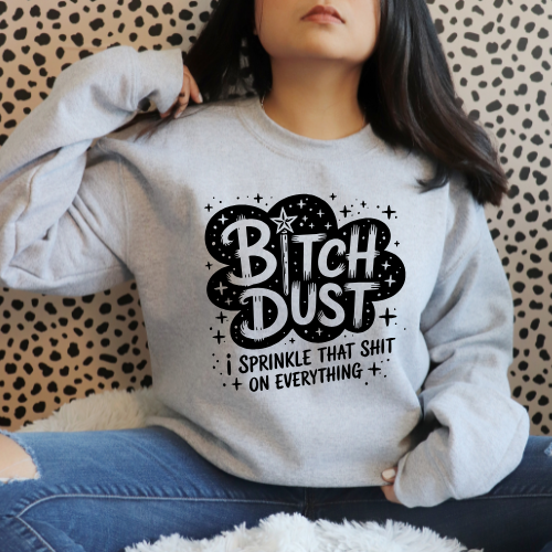 Person wearing a gray sweatshirt with 'Bitch Dust' text design.