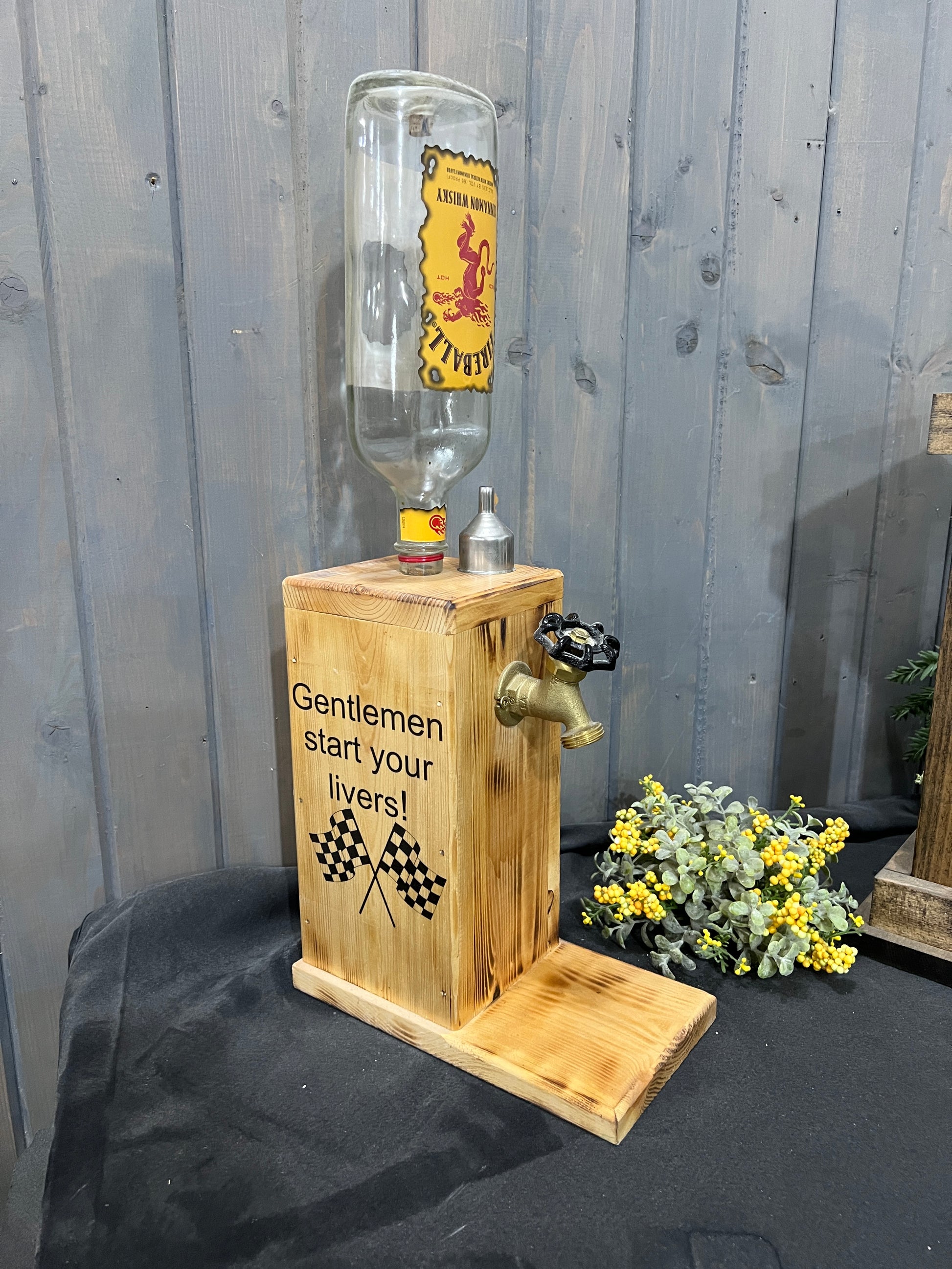 Rustic torched wood bar dispenser with permanent Fireball bottle and spigot.