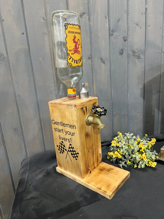Fireball whisky liquor dispenser with ‘Gentlemen, Start Your Livers’ and two checkered flags burned into the sides.