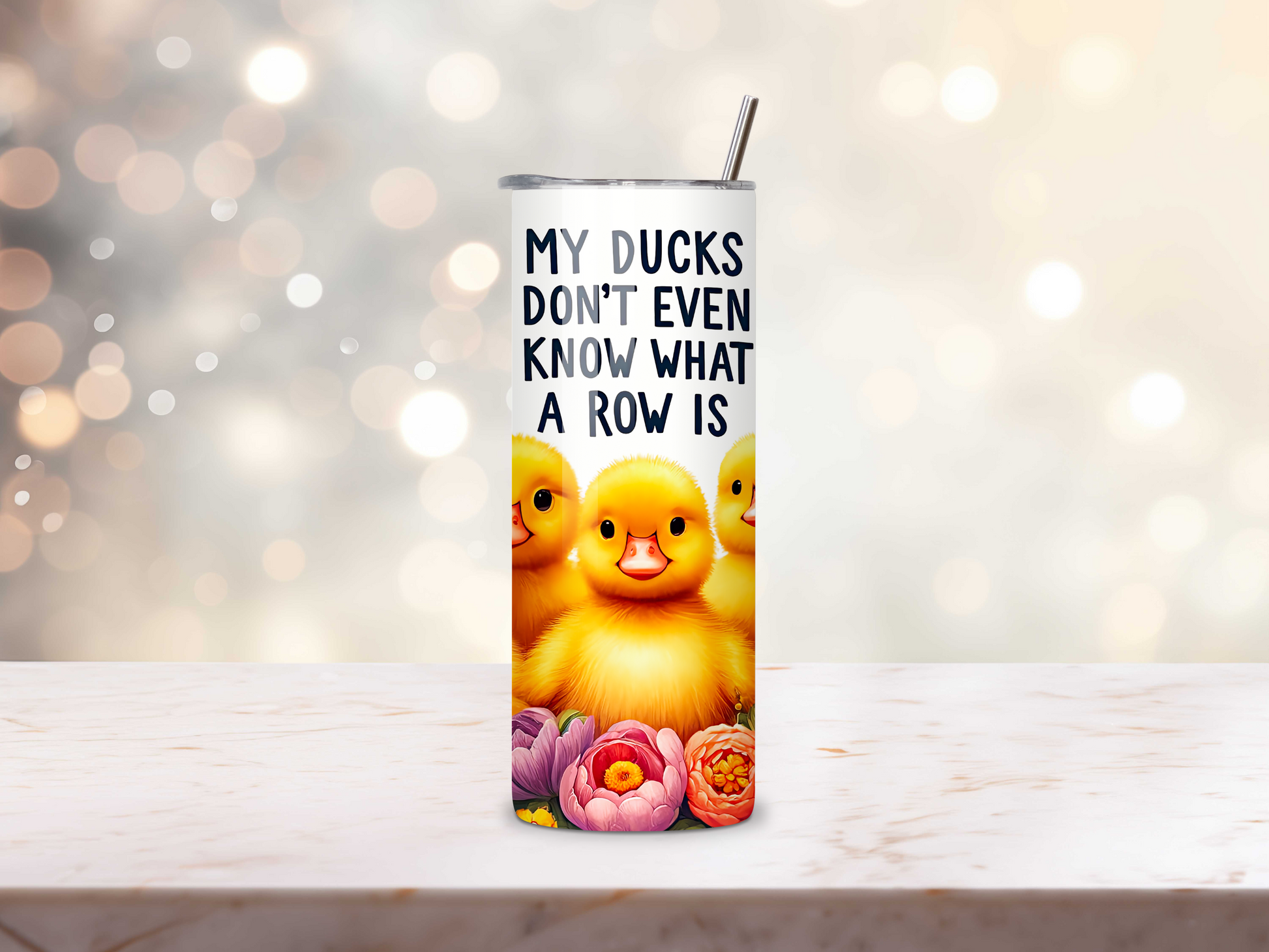 Close-up of funny tumbler with ducks and floral accents.