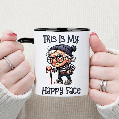 Cartoon grumpy old man with a cane on a white coffee mug with the phrase "This Is My Happy Face"