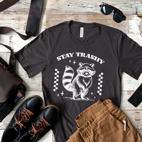 Funny raccoon t-shirt with "Stay Trashy" text β a cute & mischievous trash panda design