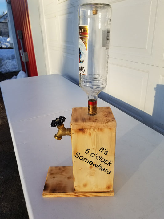 Captain Morgan liquor dispenser with ‘It’s 5 o’clock Somewhere’ burned on both sides.