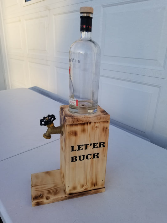Pendleton liquor dispenser with ‘Let’er Buck’ burned on both sides.