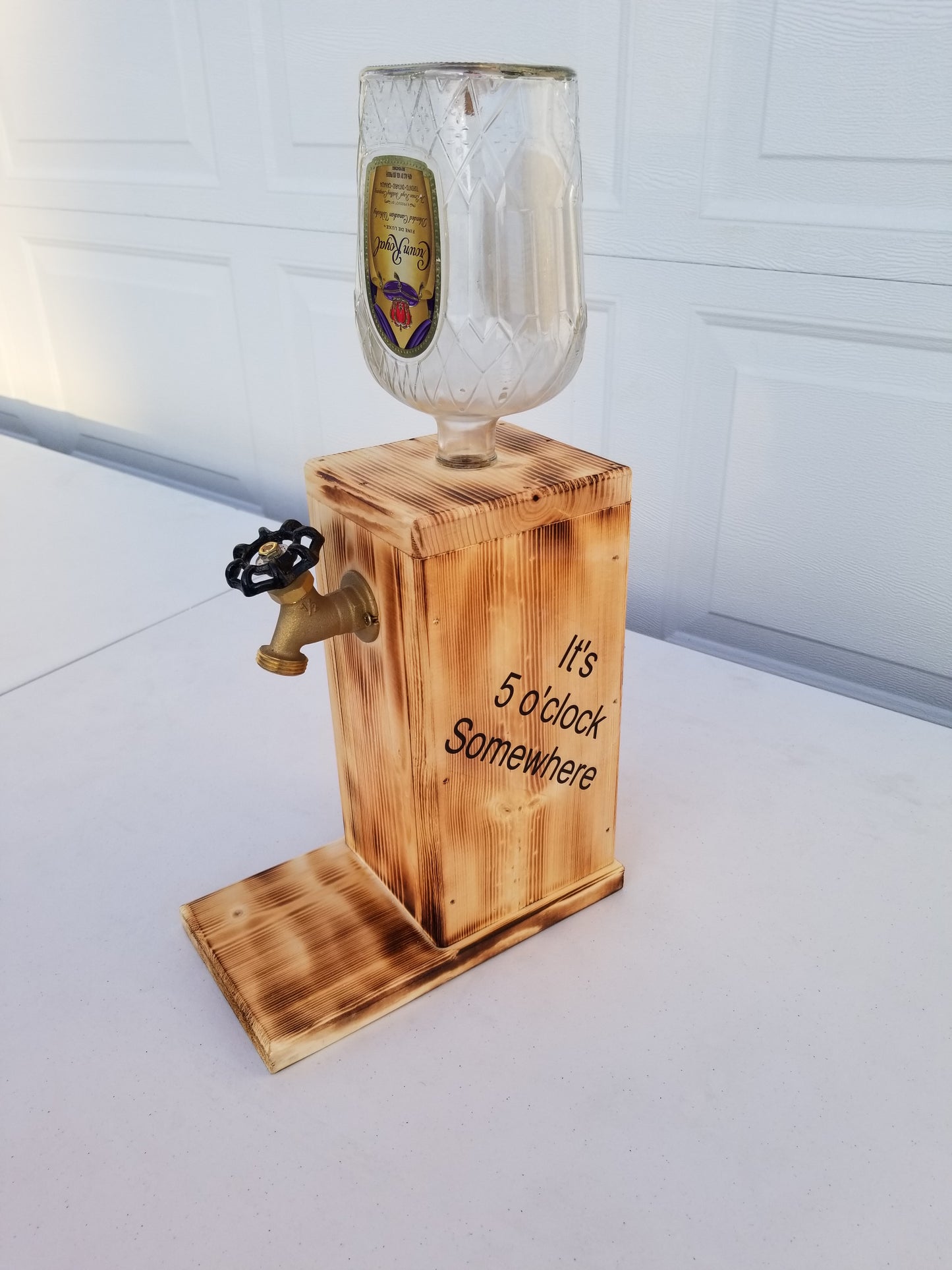 Crown Royal liquor dispenser with torched wood base and customizable side panels.