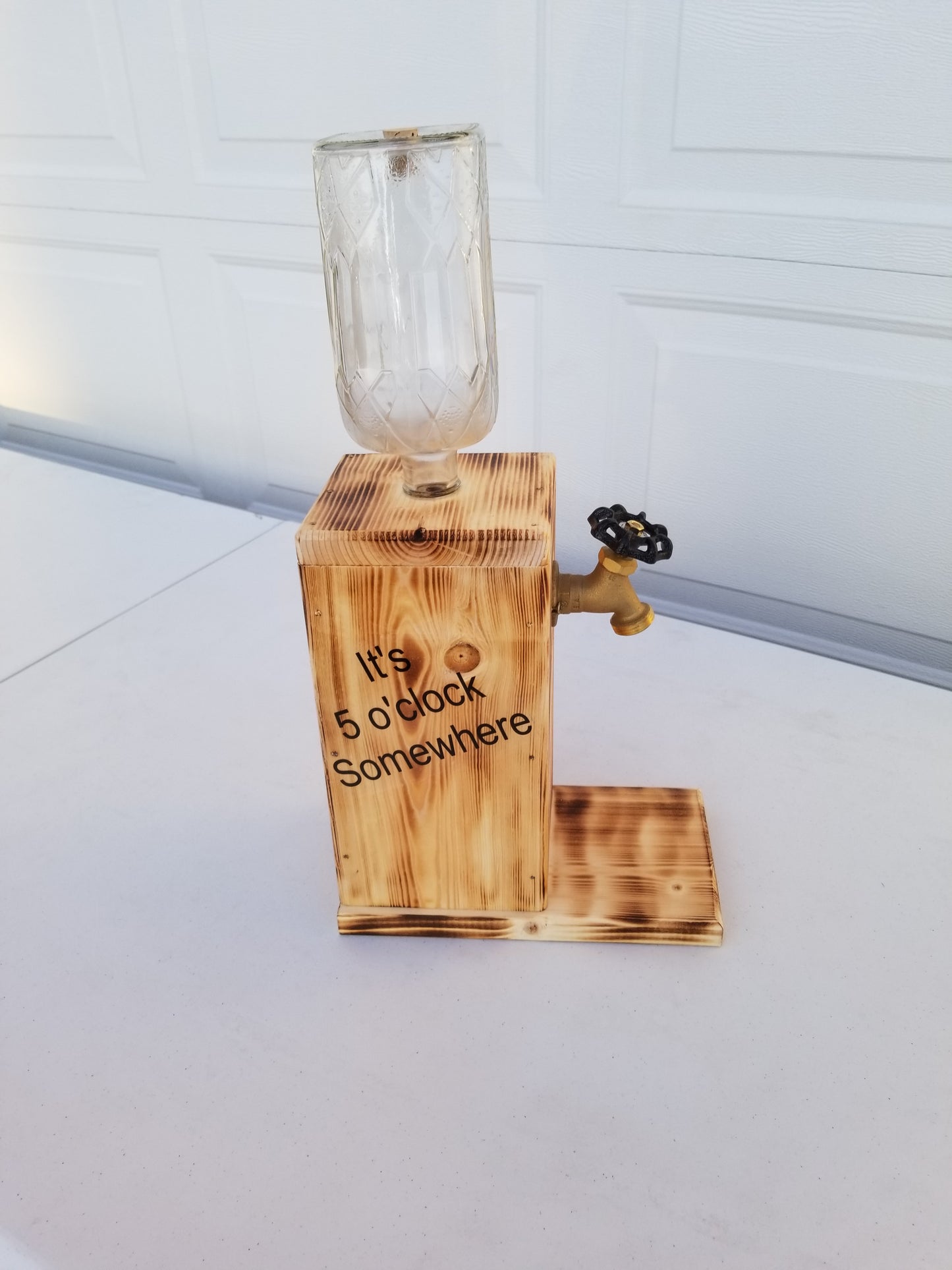 Customizable Crown Royal liquor dispenser with spigot and refill funnel.