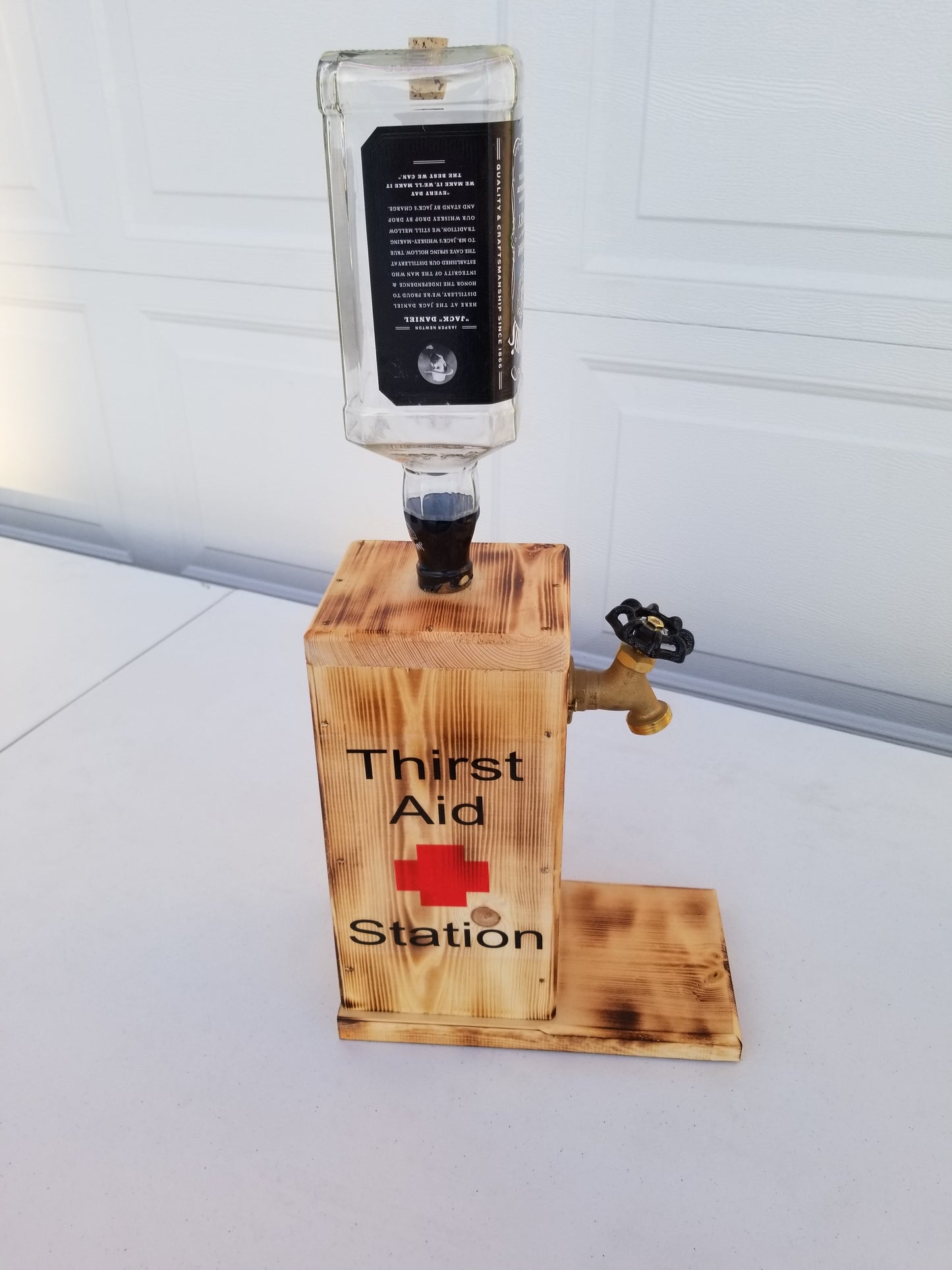 Jack Daniel’s dispenser measuring 22 inches tall, 10 inches deep, 6 inches wide.