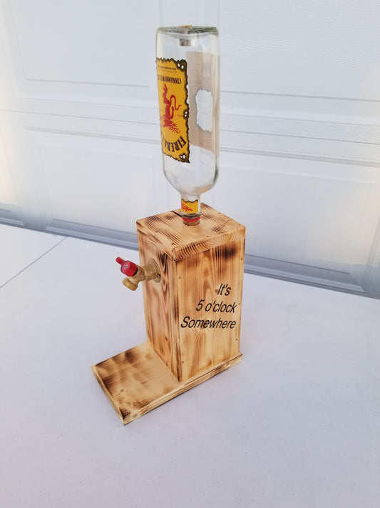 Fireball liquor dispenser with ‘It’s 5 o’clock Somewhere’ burned on both sides.