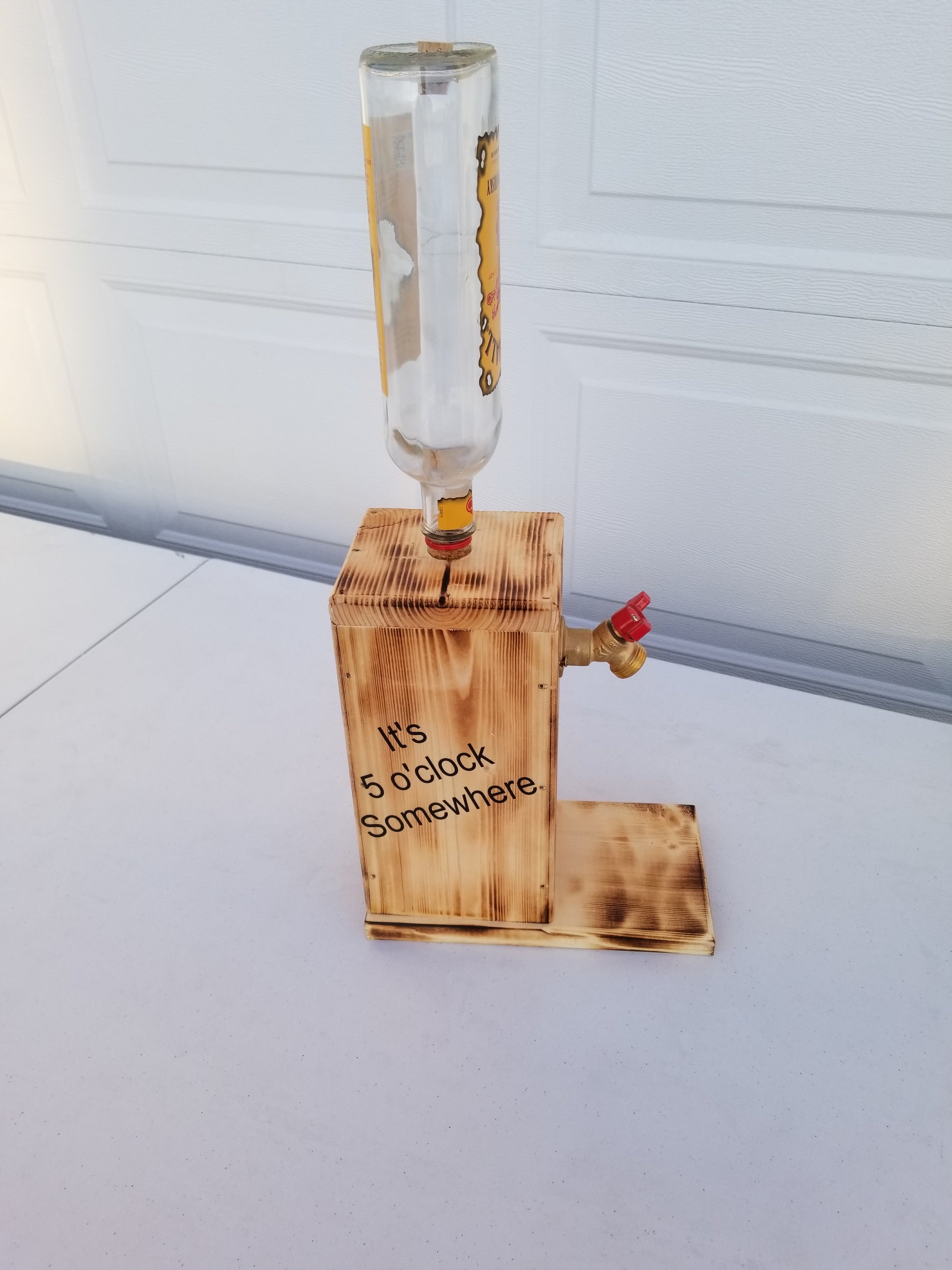 Rustic Fireball liquor dispenser with permanent bottle, spigot, and refill funnel.