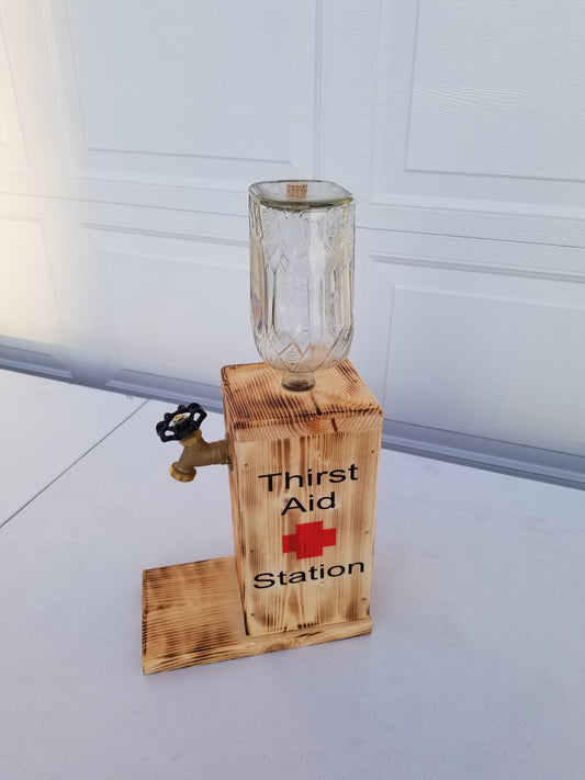 Crown Royal liquor dispenser with ‘Thirst Aid Station’ burned on both sides.