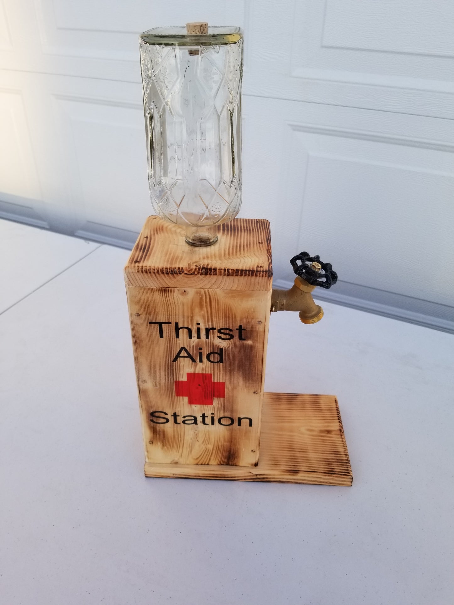 Rustic Crown Royal liquor dispenser with permanent bottle, spigot, and refill funnel.
