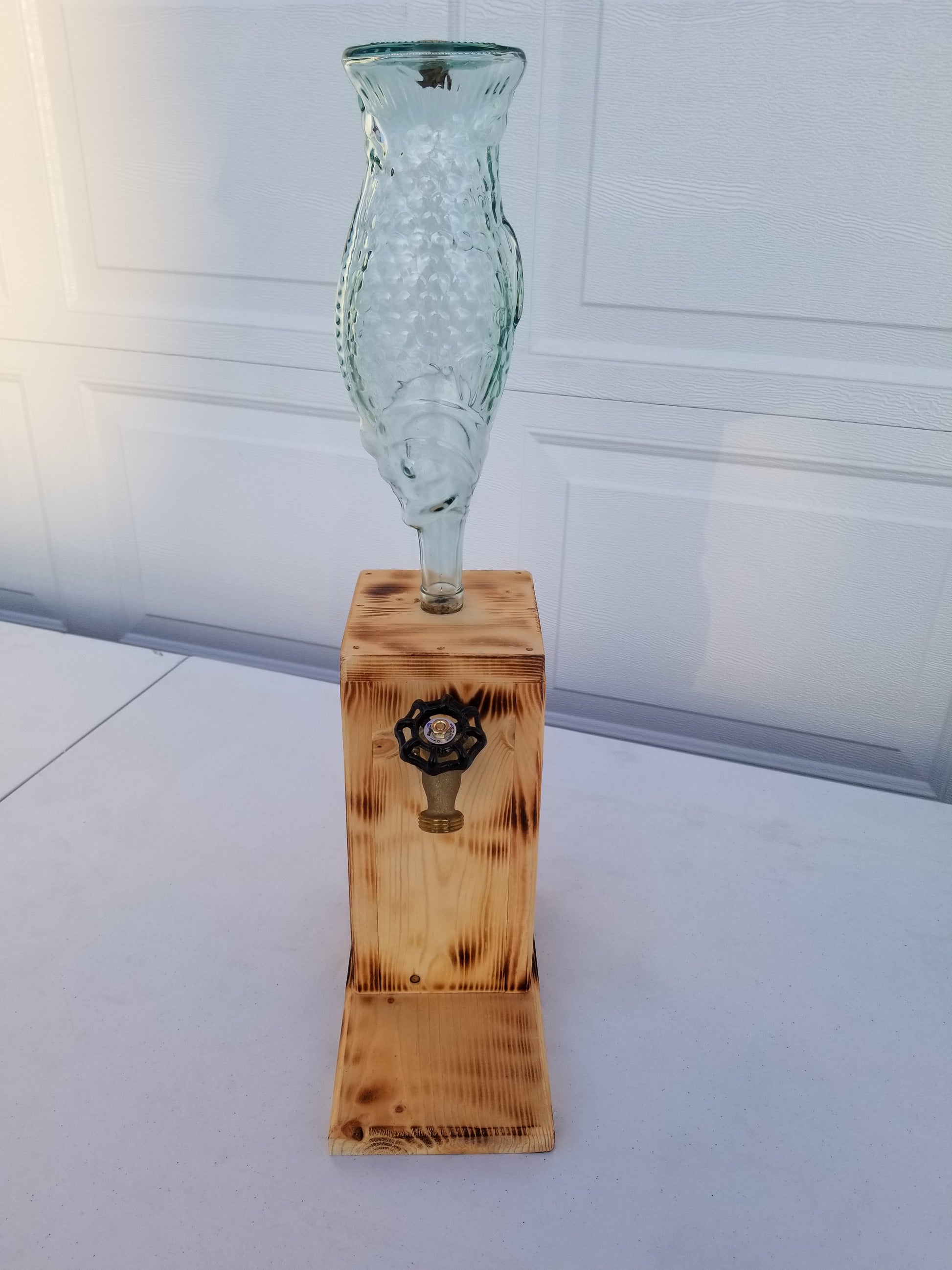 liquor dispenser with custom burned design.