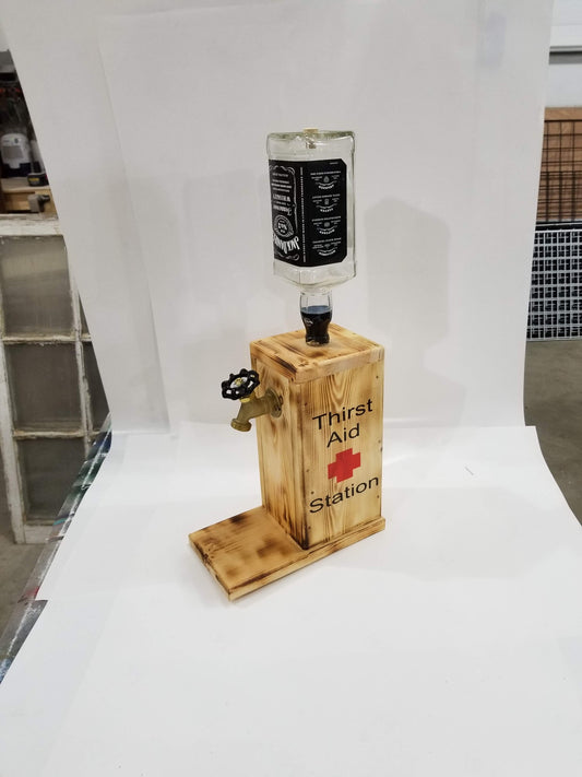 Jack Daniel’s liquor dispenser with ‘Thirst Aid Station’ burned on both sides.