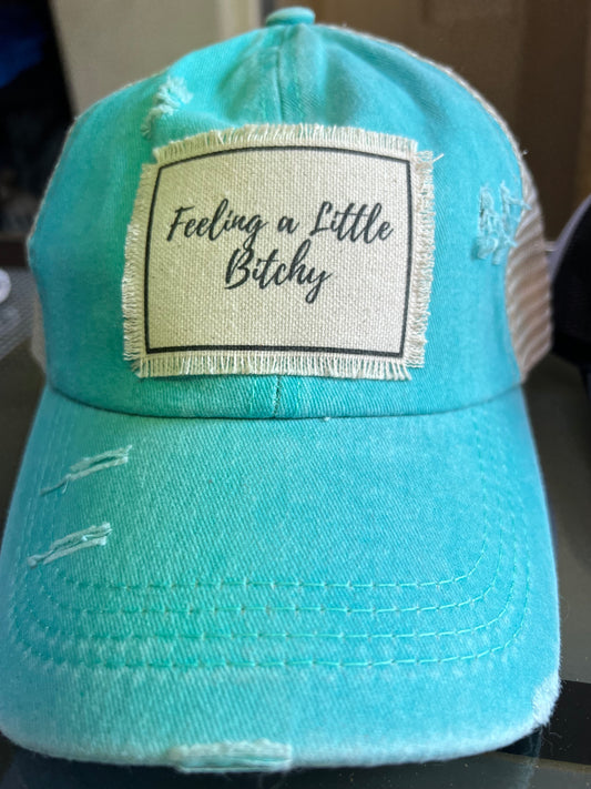 Distressed aqua ponytail hat with Feeling a Little Bitchy patch