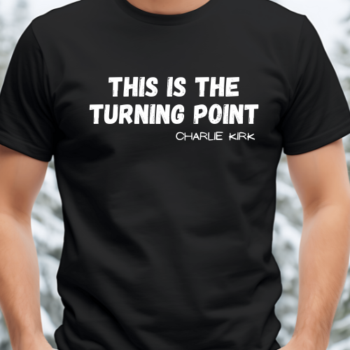 Black t-shirt with white text 'THIS IS THE TURNING POINT CHARLIE KIRK' on a blurred background