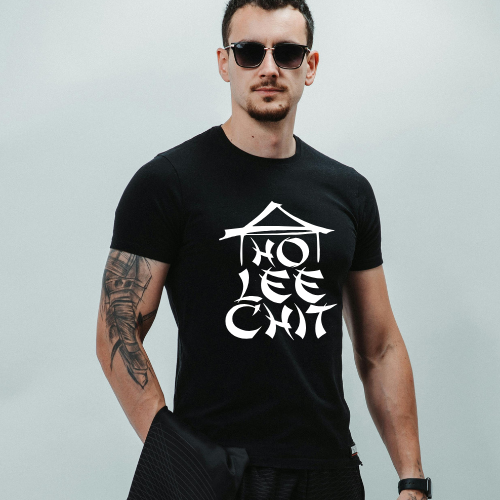 Man wearing a black t-shirt with white graphic design and text against a light gray background