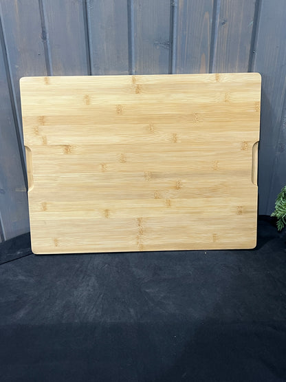 “Large engraved bamboo charcuterie board with shark design and grooved handles on back.