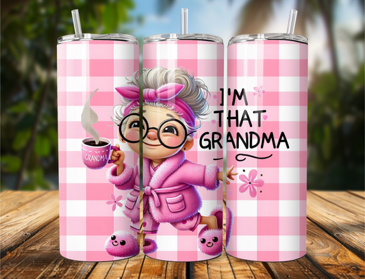Tumbler with “I’m That Grandma” design featuring a pink-robed grandma with a coffee cup and bunny slippers on a pink plaid background.