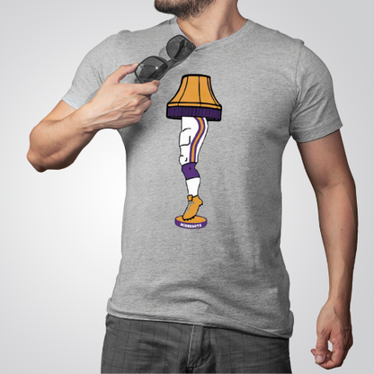 Person wearing a gray t-shirt with a lamp design, holding sunglasses.