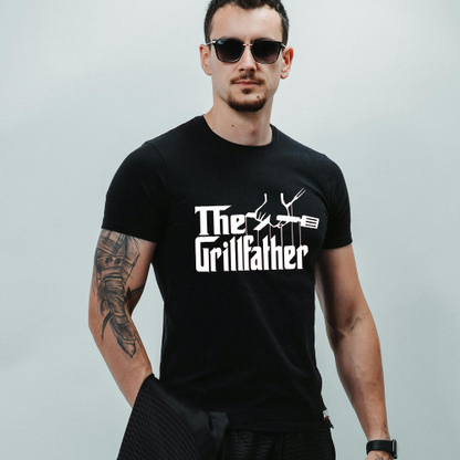 Man wearing a black t-shirt with 'The Grillfather' text and graphic on a light gray background