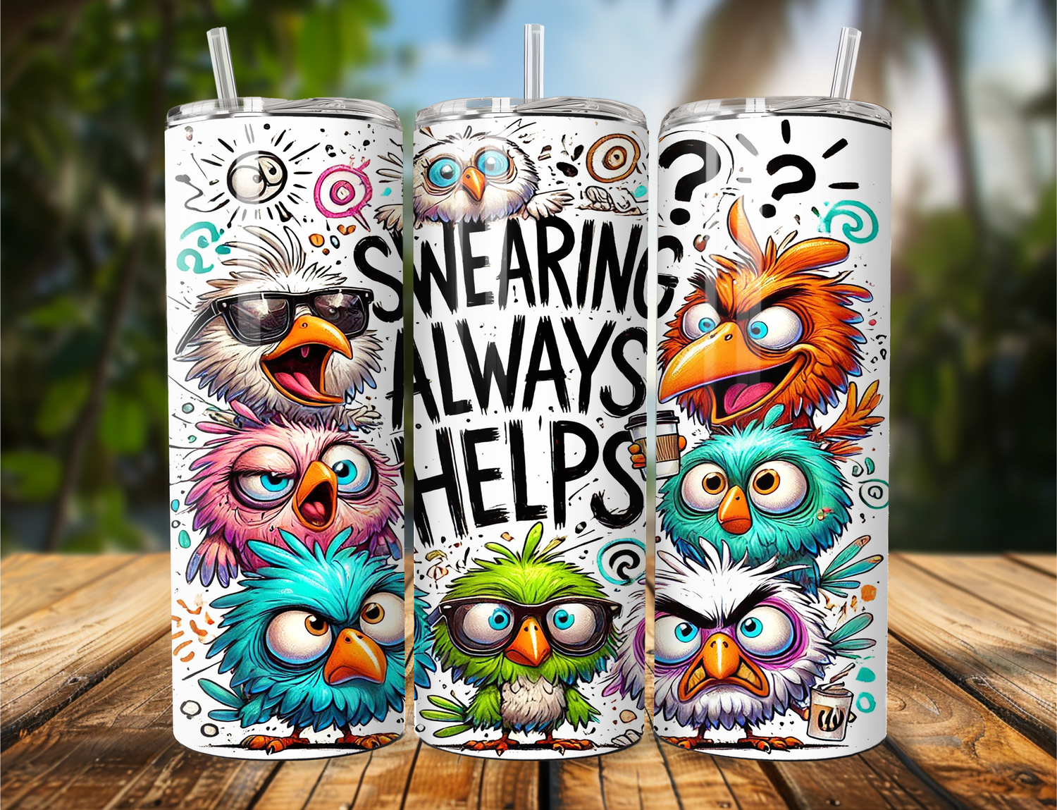 Three colorful owl-themed tumblers on a wooden surface with a blurred natural background.
