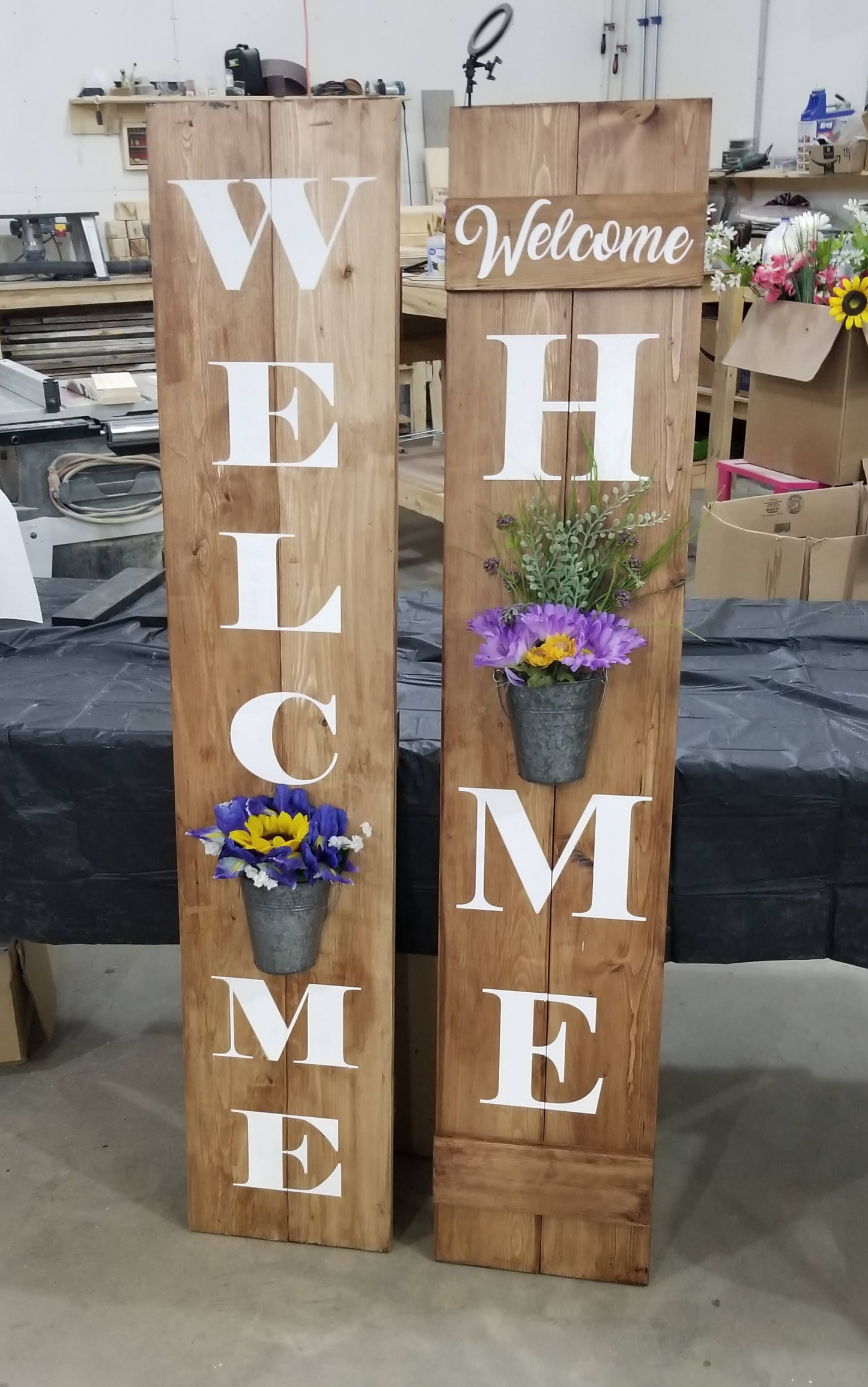 Welcome signs with flower planters