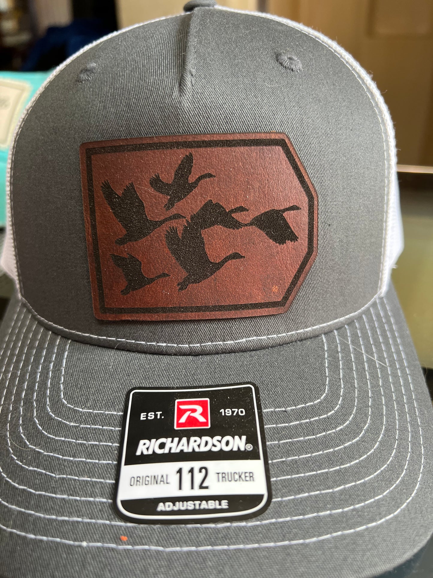 Geese flying on a leather patch hat